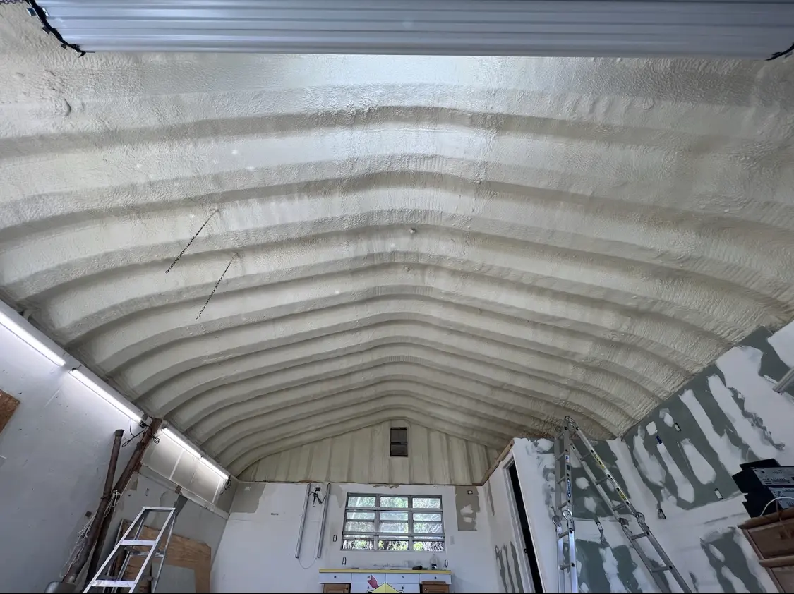 Spray polyurethane foam applied to the underside of a metal roof deck in Posen